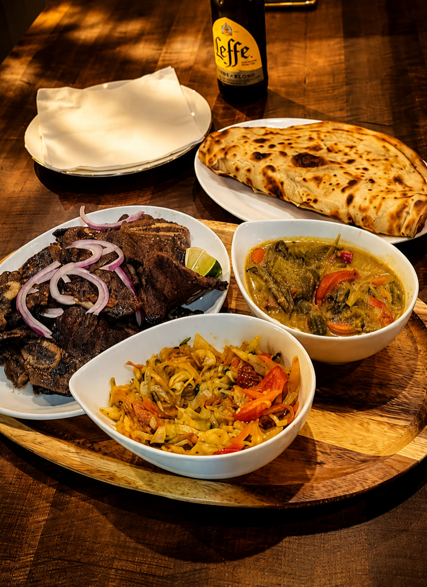 Grilled nyama choma with red onion, chapati, mchuzi and cabbage served on a wooden board