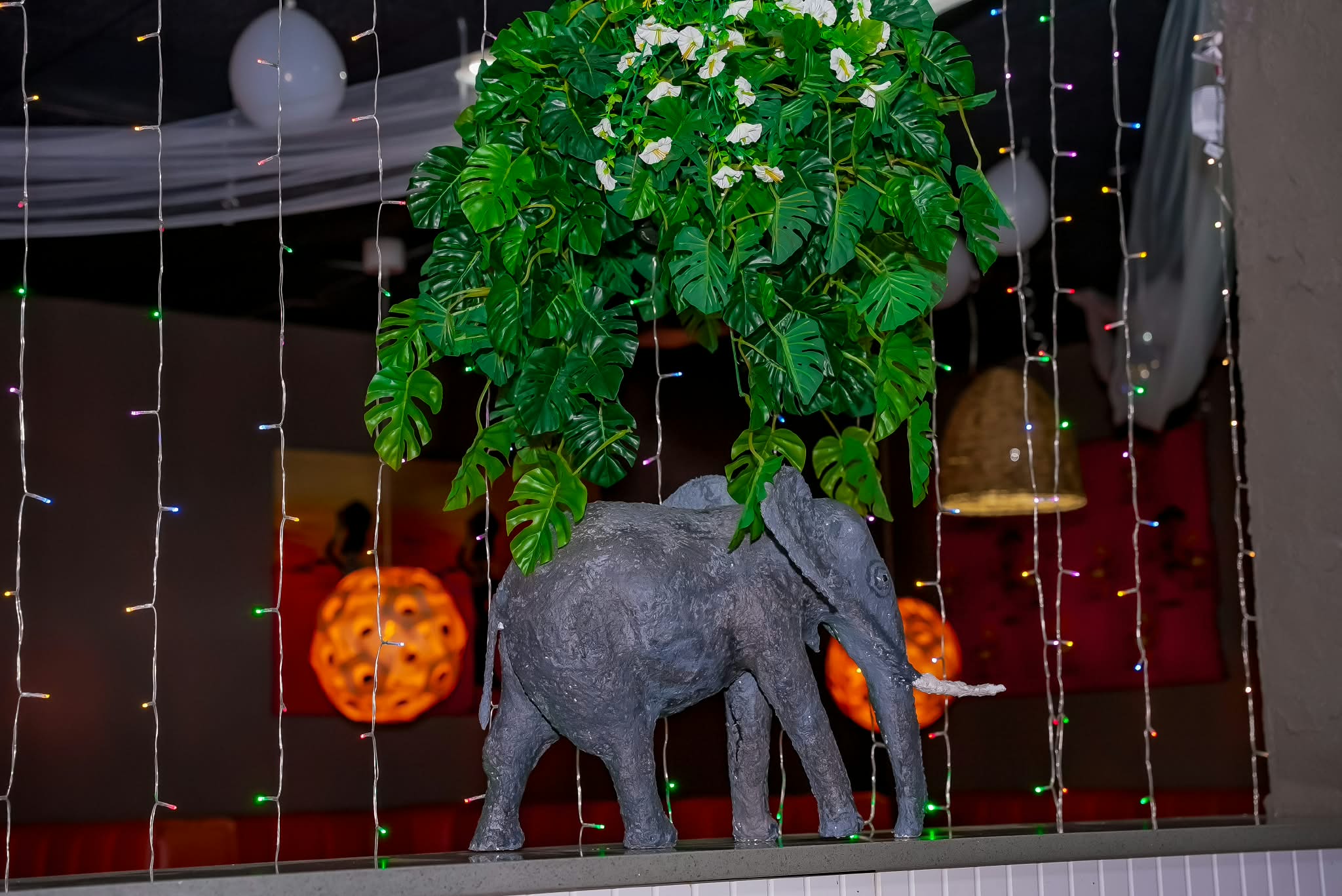 Elephant sculpture and greenery in the dining room
